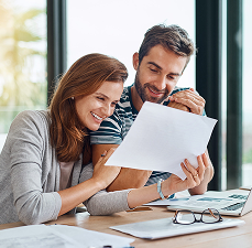 Couple sitting together reviewing a document