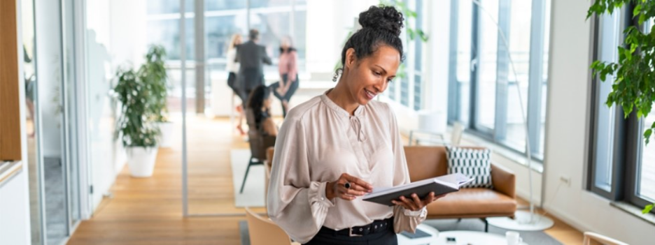 A women in office setting looks into her note